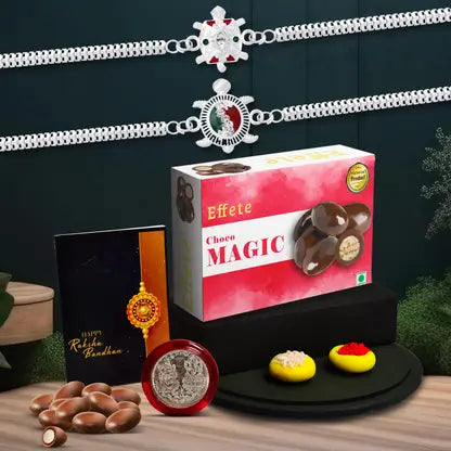 Rakhi Gift Combo With 2 Designer Rakhis For Brother Includes Choco Magic Box Silver Coin Roli Chawal Greeting Card