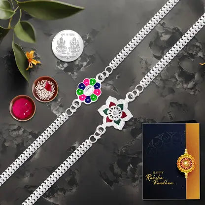Rakhi Gift Combo With 2 Stylish Floral Rakhis For Brother Includes Silver Coin Roli Chawal Greeting Card